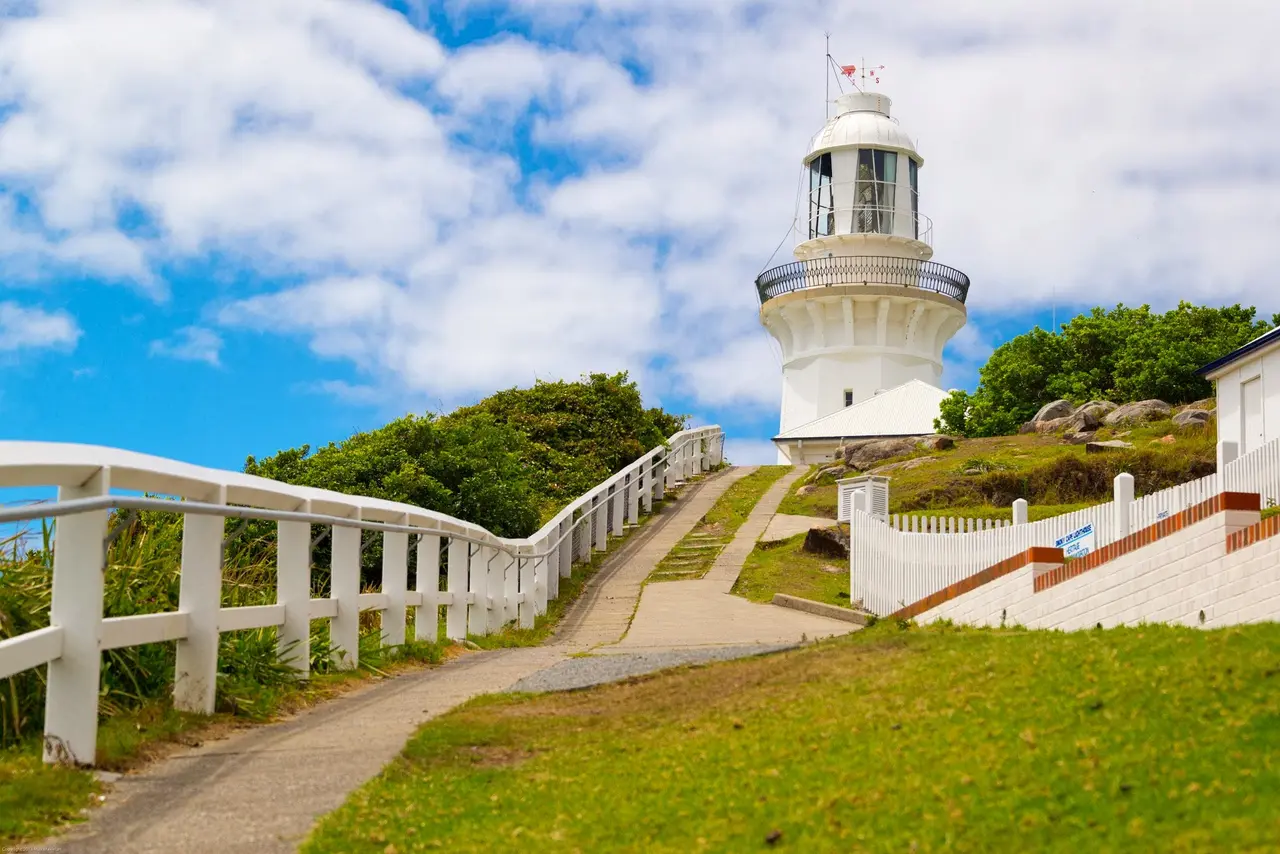 A path leading up to a coastal lighthouse — steady guidance for the road into clinical practice.
